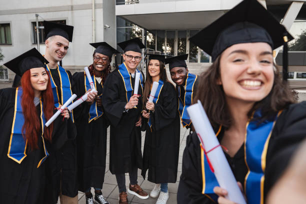 istock Group of students taking a selfie after graduation ceremony 2185628430