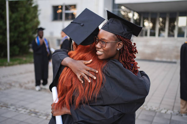 istock Two happy female students hugging after graduation ceremony 2185628437