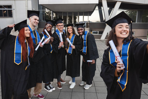 istock Group of students taking a selfie after graduation ceremony 2185628456