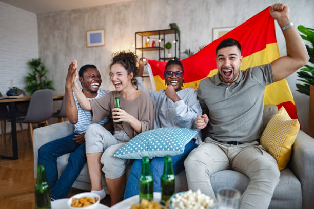 istock Friends celebrating while watching a soccer match at home 2185628746