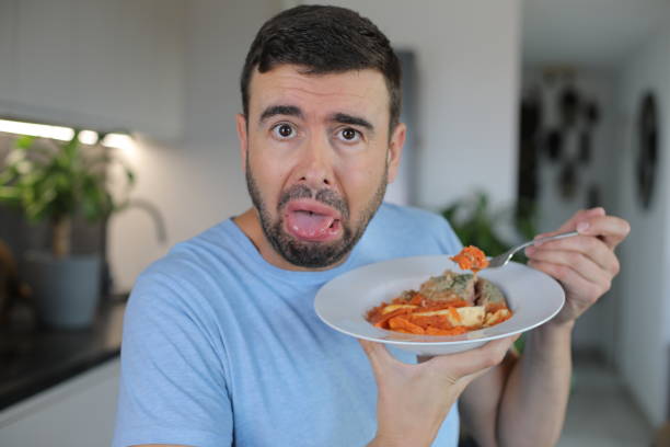 Grossed out man disliking his meal stock photo