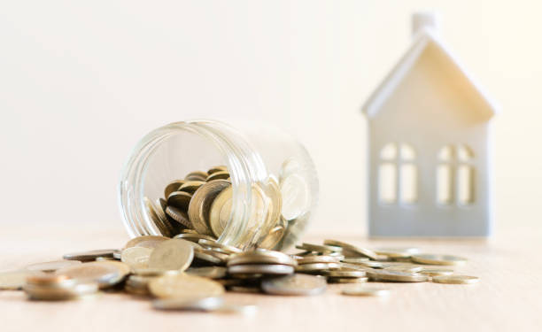 istock Real estate concept background. House model and money stack on table, copy space 2185636589