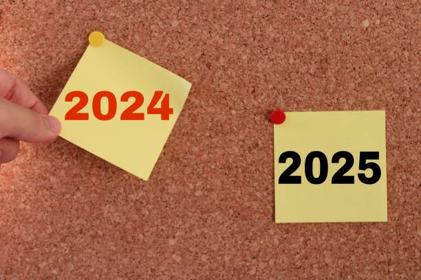 istock a man's hand pulling out a sticky note. year change from 2024 to 2025. 2025 year consept idea. 2185637194
