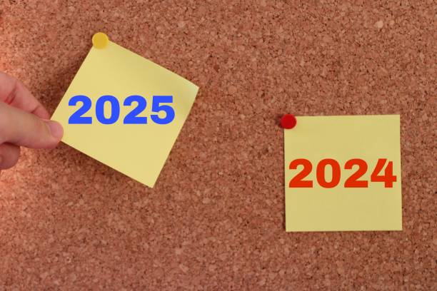 istock a man's hand pulling out a sticky note. year change from 2024 to 2025. 2025 year consept idea. 2185637195