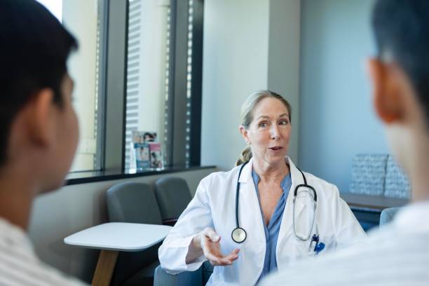 istock Pediatrician talking with twin brothers 2185637882