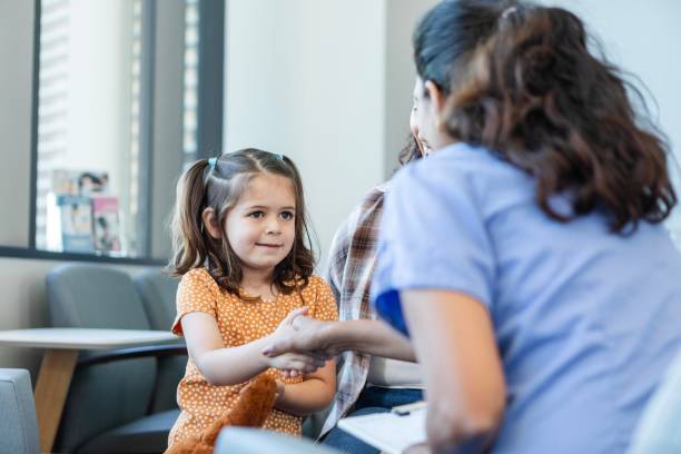 istock Pediatrician greets young patient 2185637899