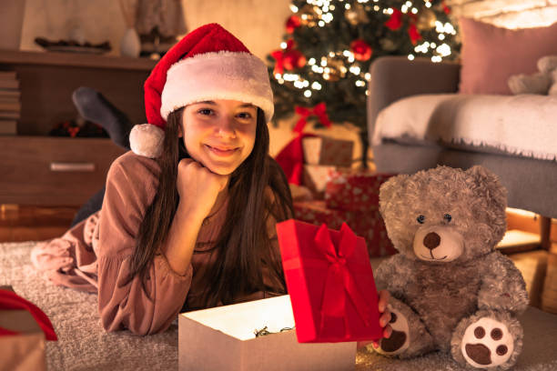 istock Cheerful girl open christmas gift 2185639795