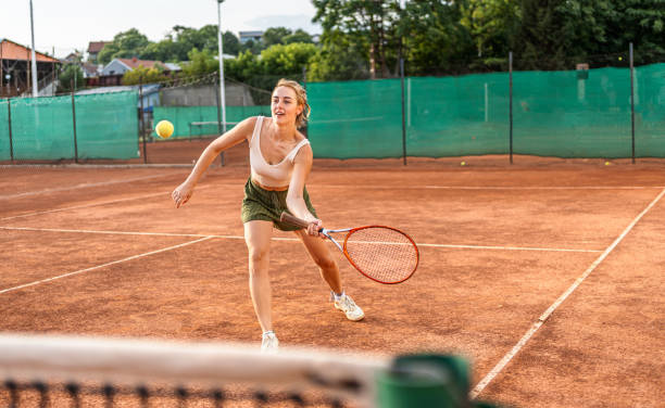 istock Young woman playing tennis 2185639929