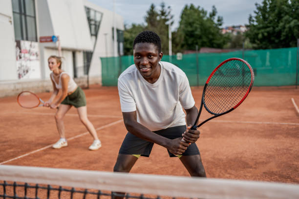 istock Young man playing tennis with his teammate 2185640755