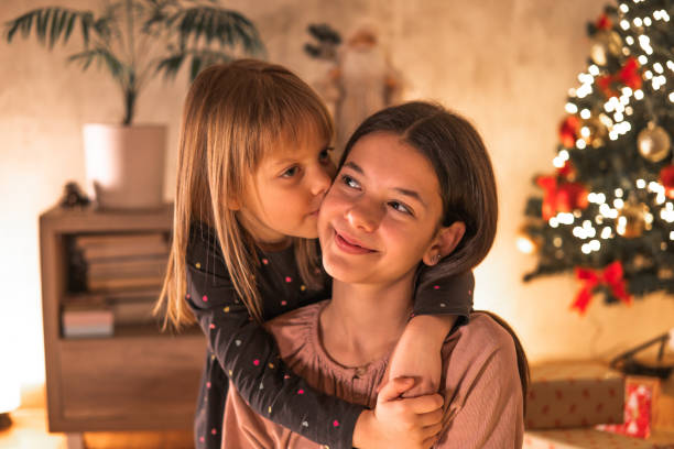 istock Two girls kissing for Christmas 2185641595