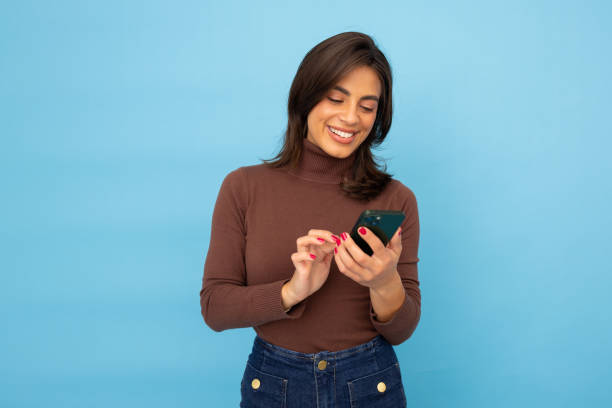 istock Young Latina businesswoman using smartphone 2185641703