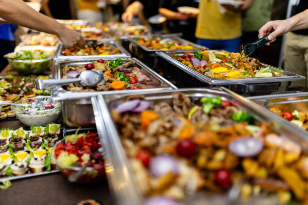istock Buffet feast featuring diverse dishes at a community gathering in an indoor hall during evening celebration 2185642278