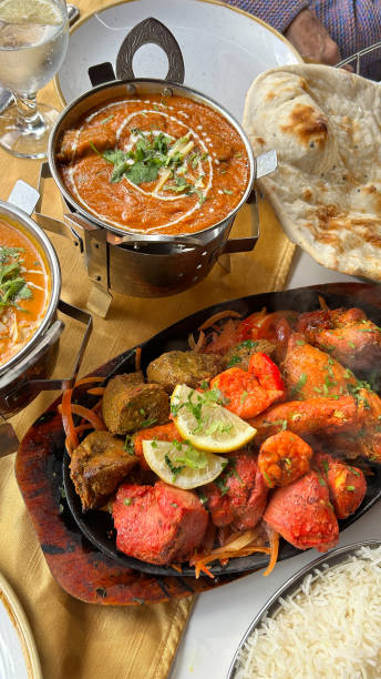 istock Indian food platter with assorted meats, rice, naan bread and sauce 2185642754