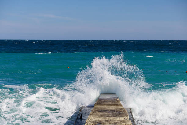 The ocean is calm and the water is blue. The waves are small and the water is still.
