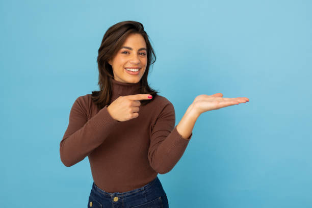 istock Young Latina businesswoman pointing at something 2185644093