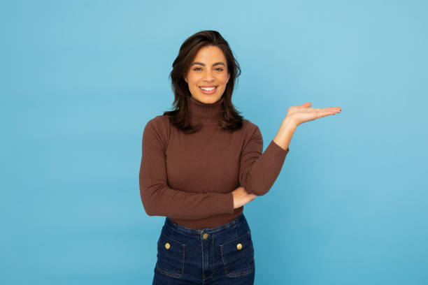 istock Young Latina businesswoman pointing at something 2185644094
