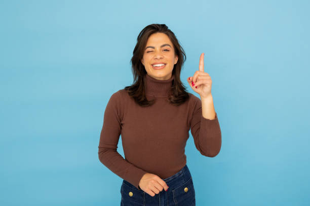 istock Young Latina businesswoman pointing at something 2185644096