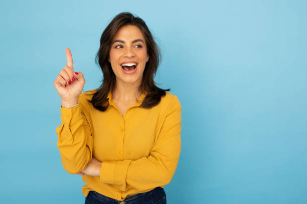 istock Ambitious Latina woman directing attention with a finger point 2185644284