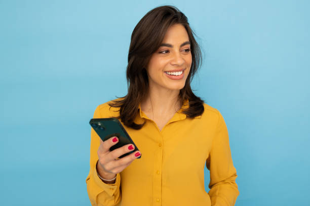 istock Focused Latina woman using her smartphone 2185644409