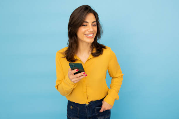 istock Professional Latina woman focused on her mobile screen 2185644487