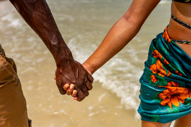 Couple Holding Hands on Tropical Beach Walk