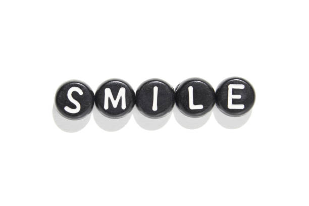 istock Smile in black and white: letter beads on white background capture simplicity 2185646438