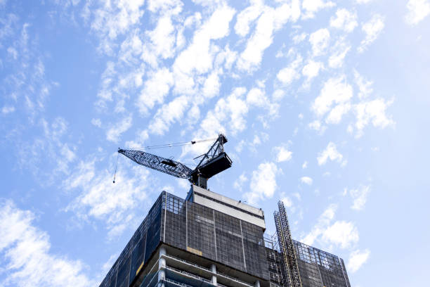 Construction of skyscrapers in city, sky background with copy space, full frame vertical composition