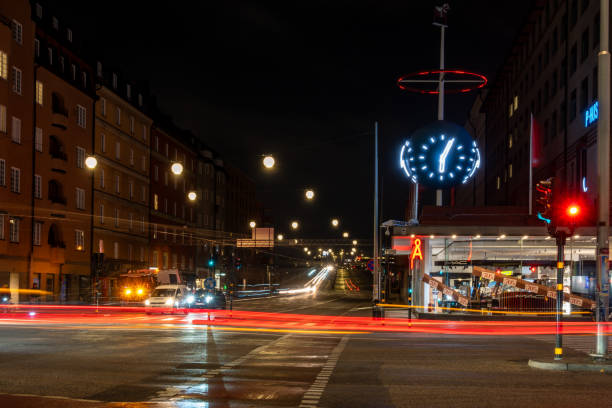 Stockholm, Sweden Oct 21, 2024 A view at night with traffic light trails of an intersection at night in the Skanstull district.