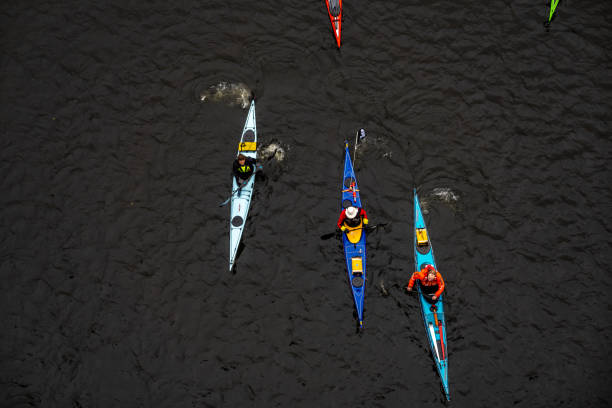 Looking down on rowers in canoes on the River Wensum in Norwich. August 2023
