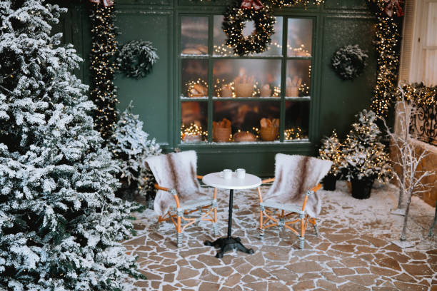istock Cozy winter seating area with snow-covered trees and holiday decorations 2185647637