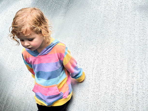 One year old portrait outside in the rain looking sad and emotional