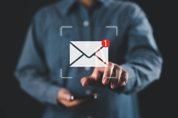 istock New email notification interaction concept. A person interacting with a floating digital interface showing a new email notification symbol, a concept for online communication. E-mail marketing, 2185650565