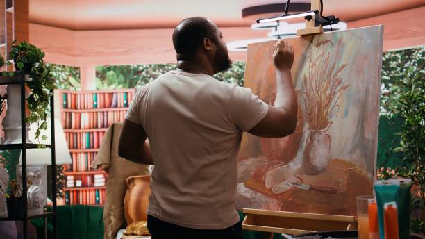istock African american artist using his skill to paint a new creation in art studio 2185650677