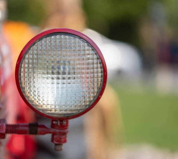 Close up of red headlight on old tractor