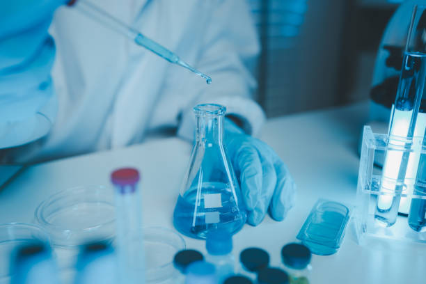istock a chemist examines a sample of a liquid in a laboratory, a laboratory filled with scientific experiment equipment, microscope, female scientist, female chemist, researcher is searching for scientific 2185653130