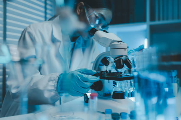 istock a chemist examines a sample of a liquid in a laboratory, a laboratory filled with scientific experiment equipment, microscope, female scientist, female chemist, researcher is searching for scientific 2185653142