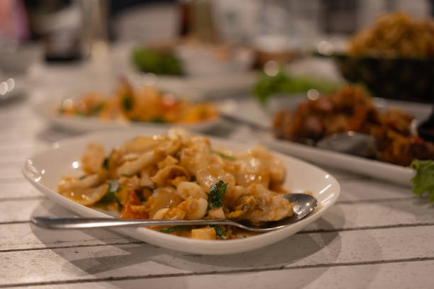 istock Stir fried squid with salted egg yolk on white dish 2185658596