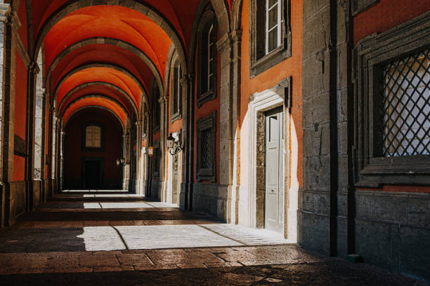 istock Historic Red Brick Archway Corridor With Sunlight and Shadows 2185659647