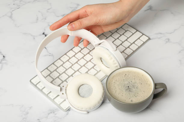 istock A cup of coffee with headphones and a keyboard on a white background 2185660199