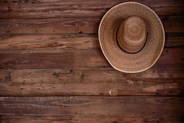 istock Straw hat on wooden wall 2185662634