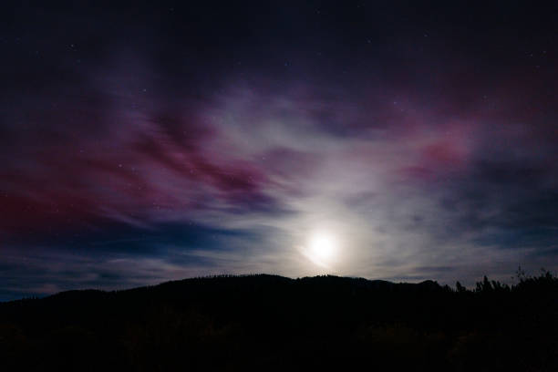 Night sky scene with purple northern lights in Clinton, Montana, United States