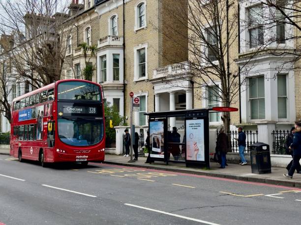 London, United Kingdom – March 04, 2024: public transportation bus stop with a double-decker bus number 328 heading to Chelsea