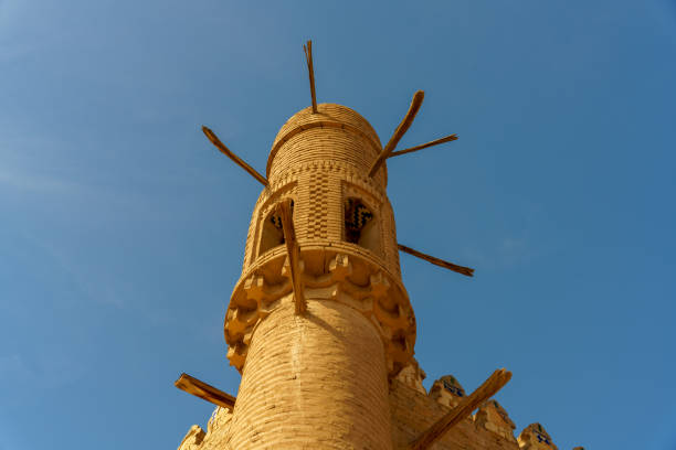 A tall building with a blue sky in the background in Khiva, Xorazm Region, Uzbekistan
