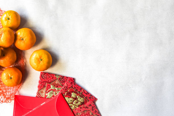istock mandarin oranges and stacks of red envelopes as Chinese New Year decorations with negative space. 2185664123