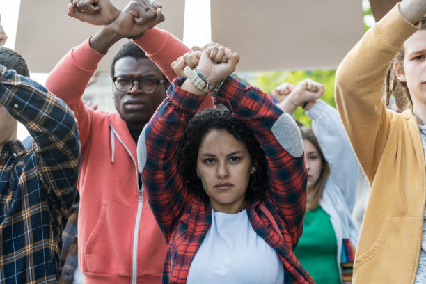 istock Diverse youth activists raise fists in unity: multicultural protest for social change 2185670338