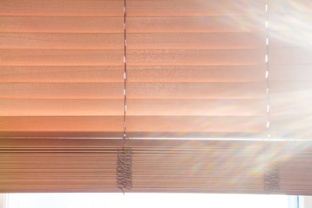 istock Window with brown wooden blinds close-up front view. 2185671259