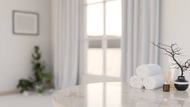 istock A luxury marble table features towels, a reed diffuser, and a ceramic vase in a luxury white room. 2185671864