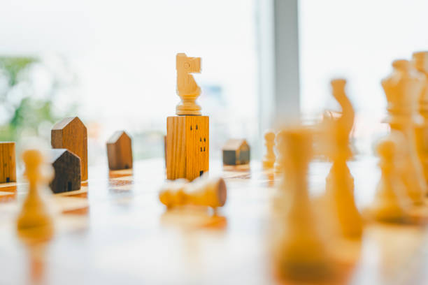 istock Chess, Building and house models in chess game, competition success play. strategy, management or leadership concept 2185673825