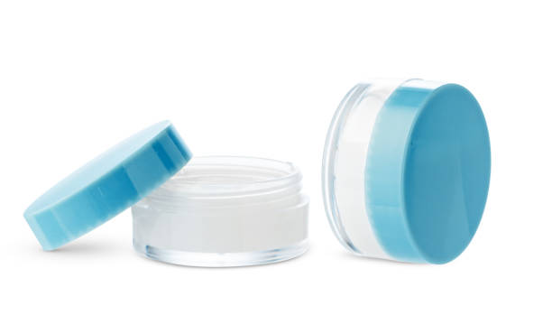 Two open cosmetic jars showcasing different creams set against a clean white background