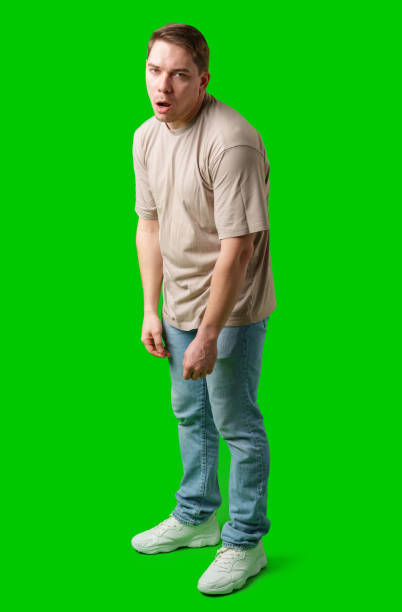 istock Man making a humorous expression against a bright green background 2185680707